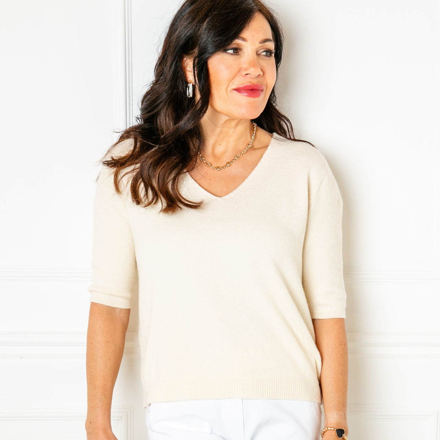 The cream Knitted Short Sleeve Top with a v neckline and 3/4 length sleeves