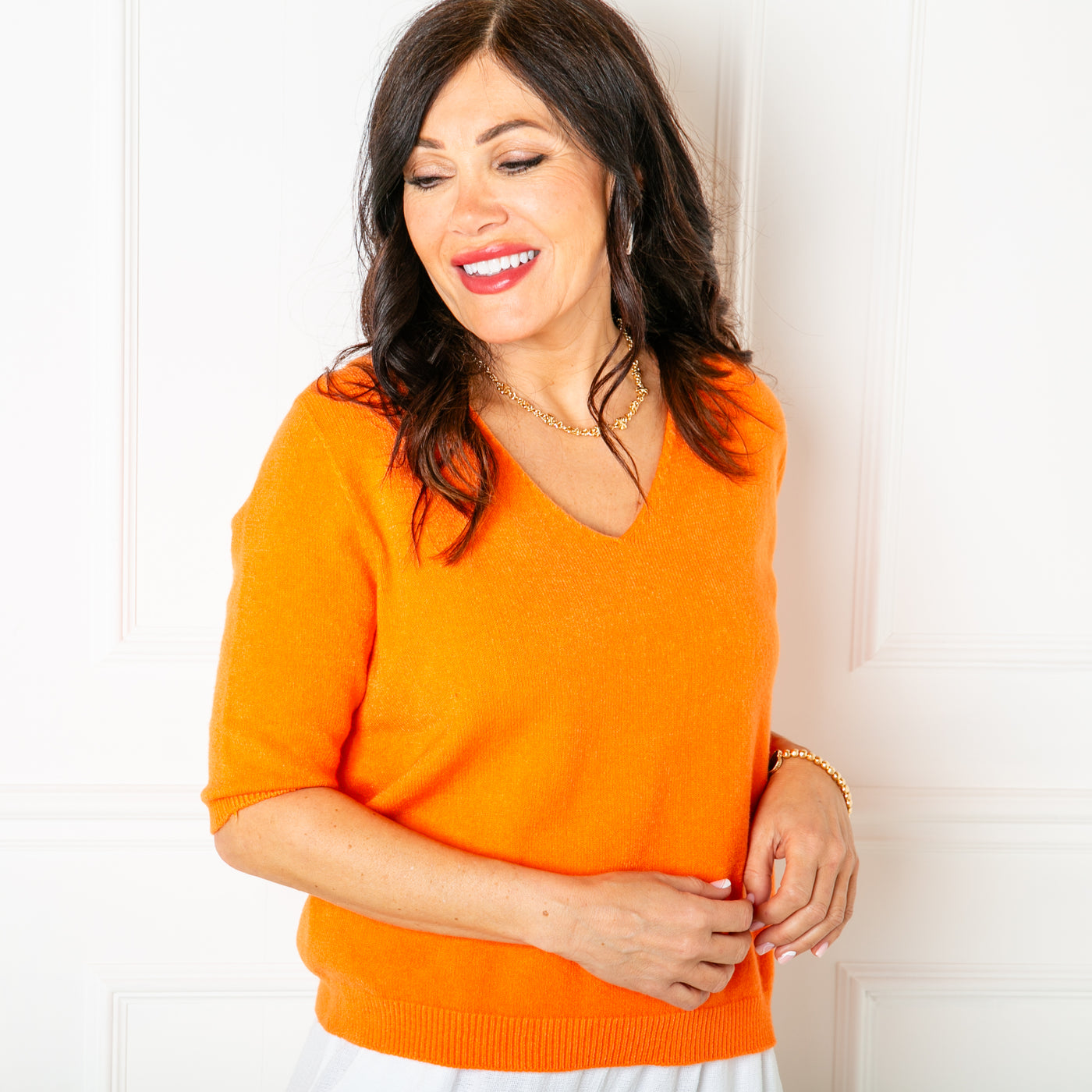 The orange Knitted Short Sleeve Top with a v neckline and 3/4 length sleeves