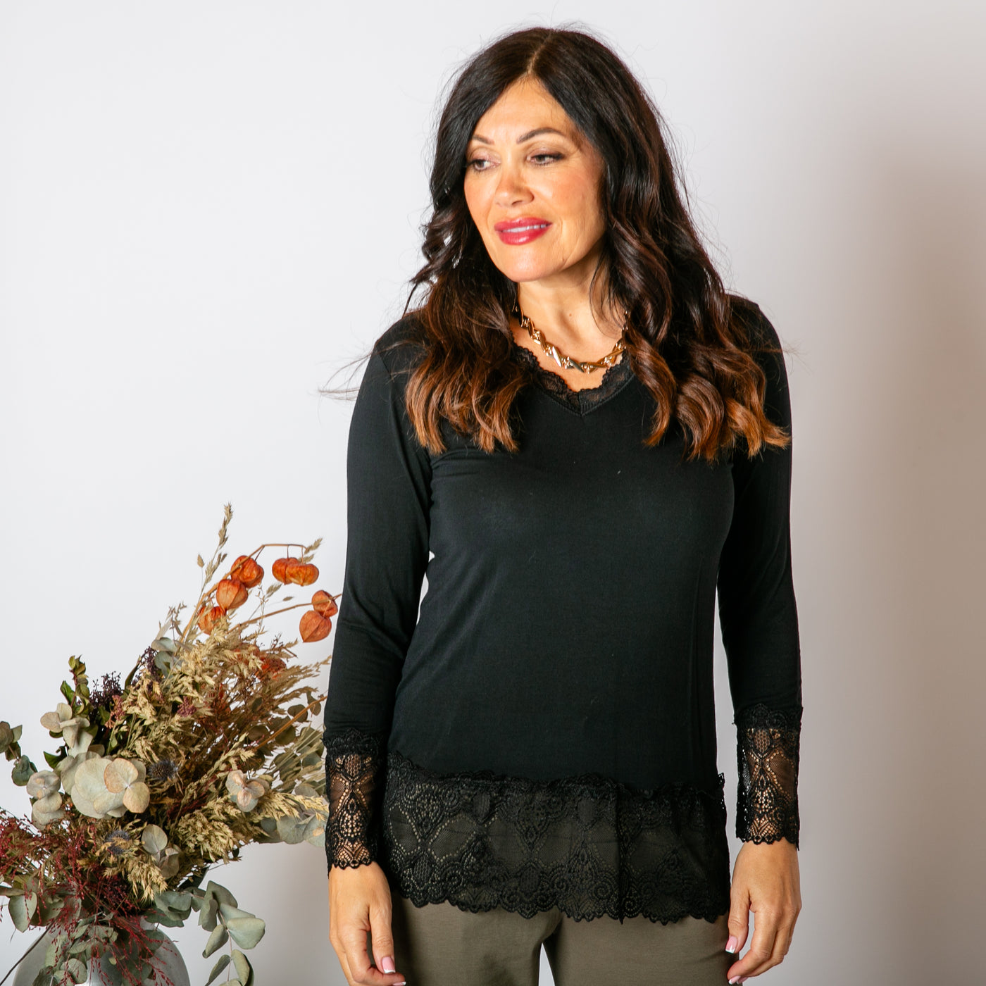 The black Lace Trim Top with long sleeves and a v neckline