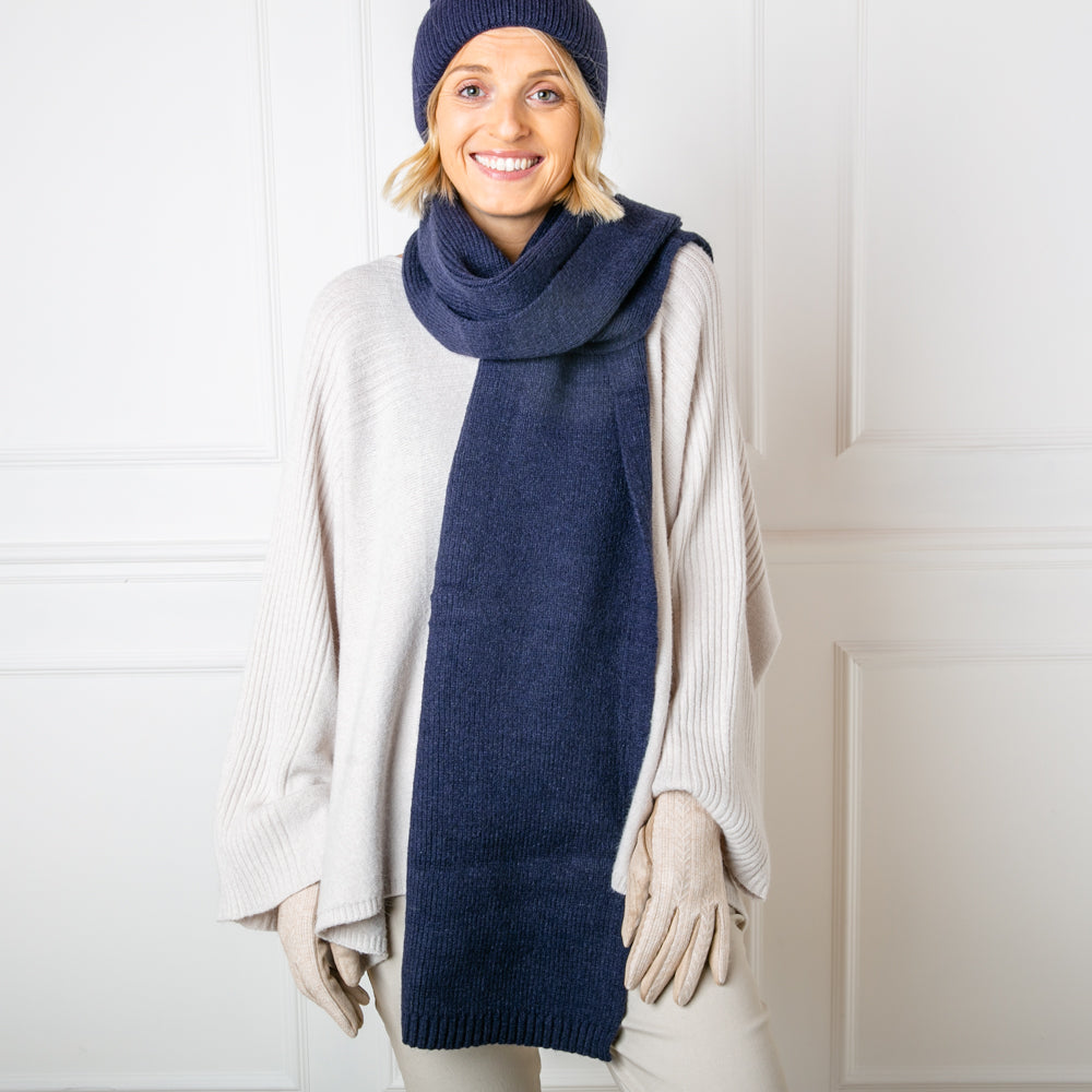 The Layla Scarf in navy blue made from a ribbed knitted blend of wool and viscose