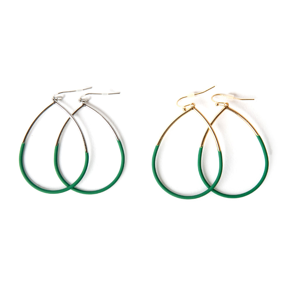 The Leah Earrings in emerald green featuring a teardrop shape. Available in gold and silver