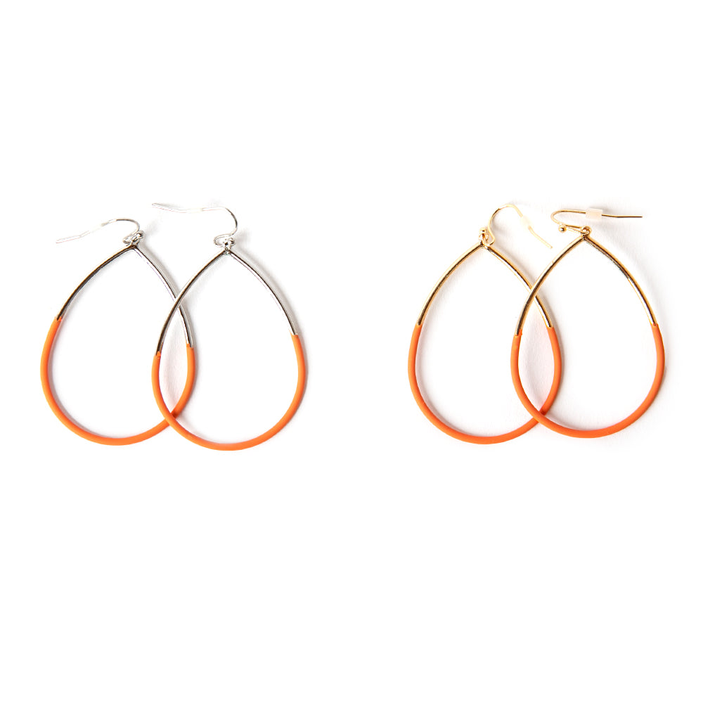 The Leah Earrings in orange featuring a teardrop shape. Available in gold and silver