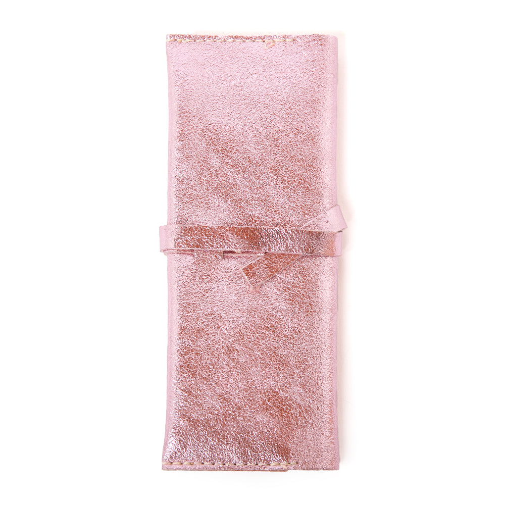 The Leather Jewellery Wrap Pouch in pink with a wrap around tie fastening so you can fill to your hearts content