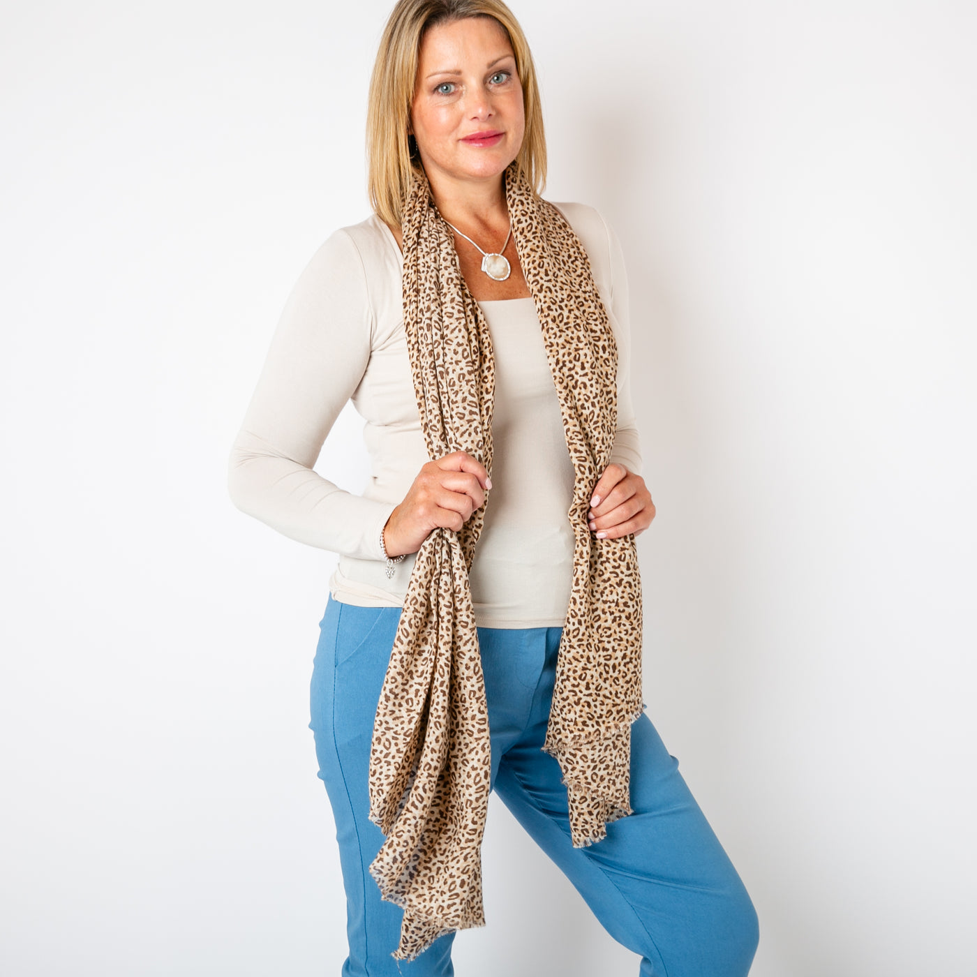 The stone cream Leopard Print Scarf featuring a fun, bold animal print pattern