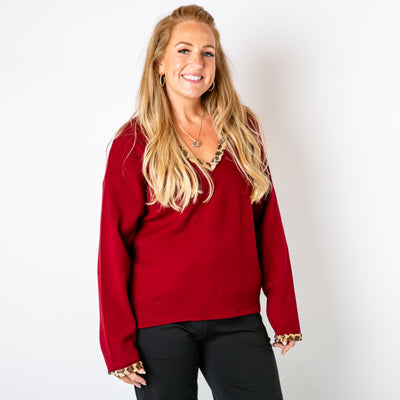 The burgundy red Leopard Trim Jumper with animal print faux fur trims around the neckline and sleeve cuffs