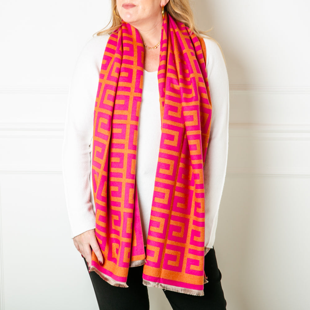 The Libby Pattern Scarf in pink and orange, super soft and cosy, made from a blend of viscose and wool