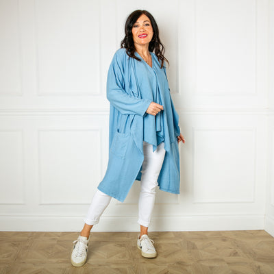 The denim blue Lightweight Waterfall Jacket with pockets on either side and an open draped front