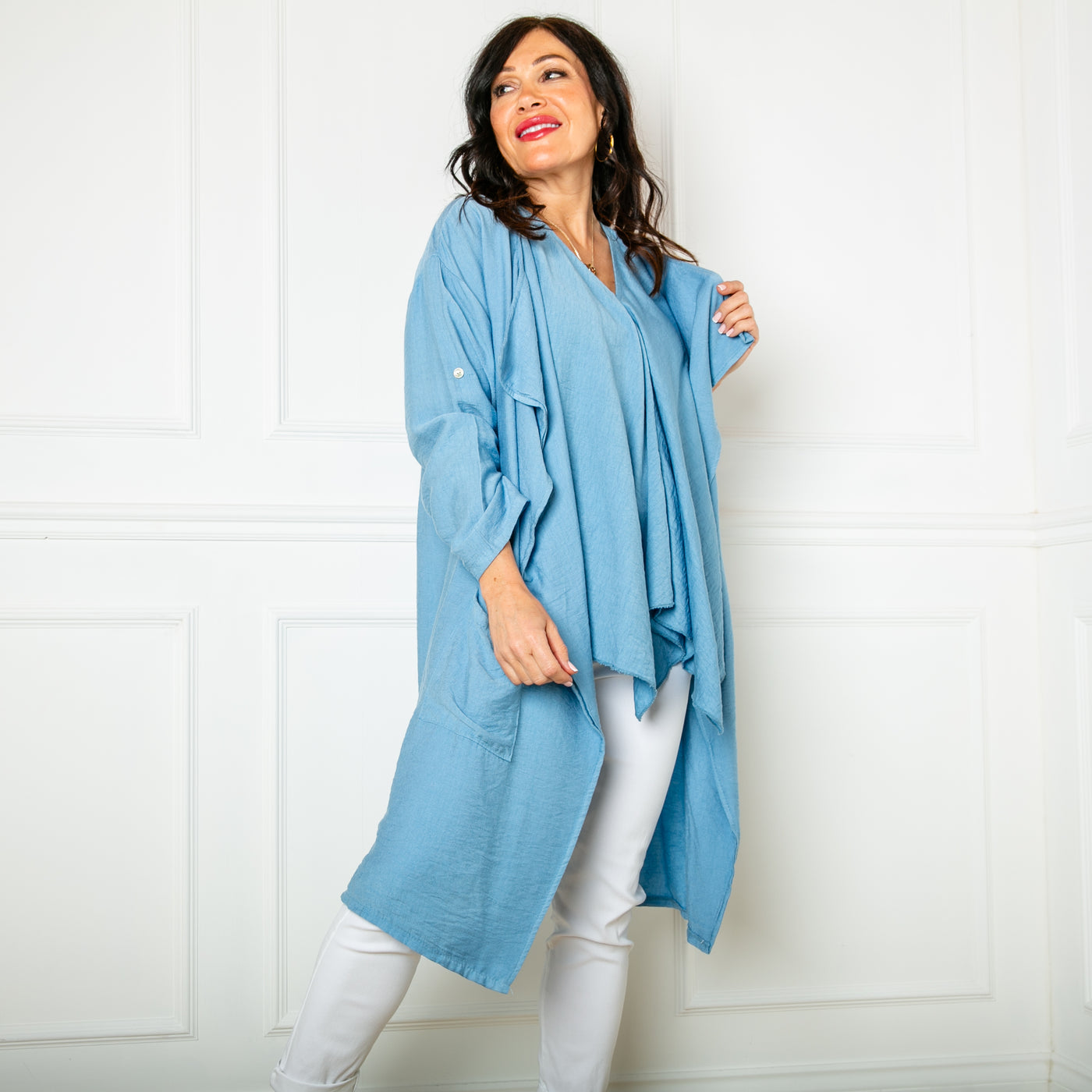 The denim blue Lightweight Waterfall Jacket with long sleeves that can be rolled up and buttoned at the elbow