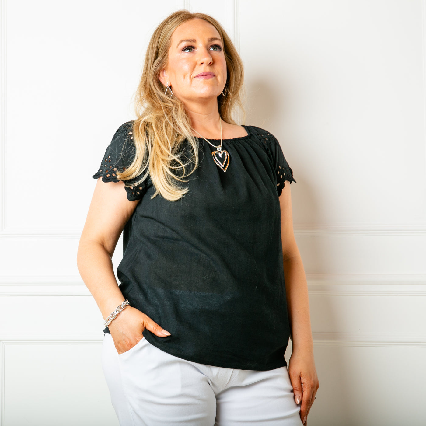 The black Linen Blend Flutter Top with an elasticated bardot neckline so the top can be worn on or off the shoulder