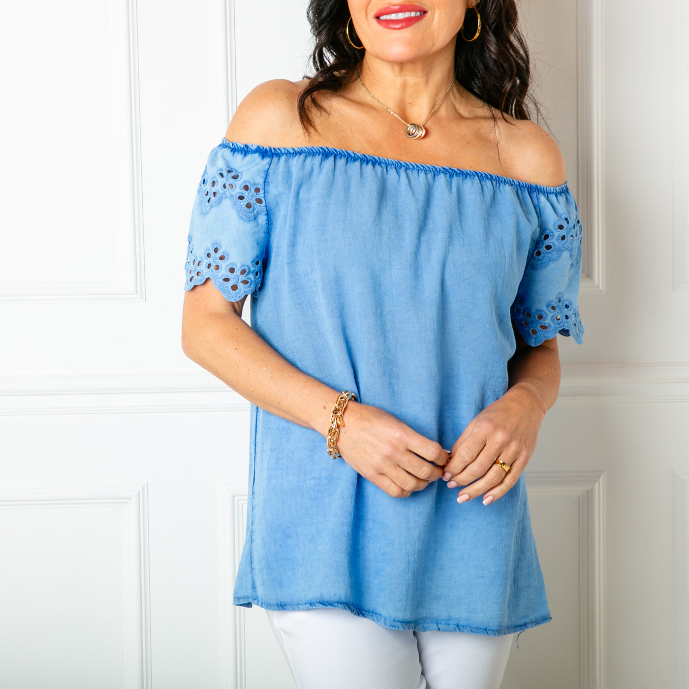 The denim blue Linen Blend Flutter Top with an elasticated bardot neckline so the top can be worn on or off the shoulder