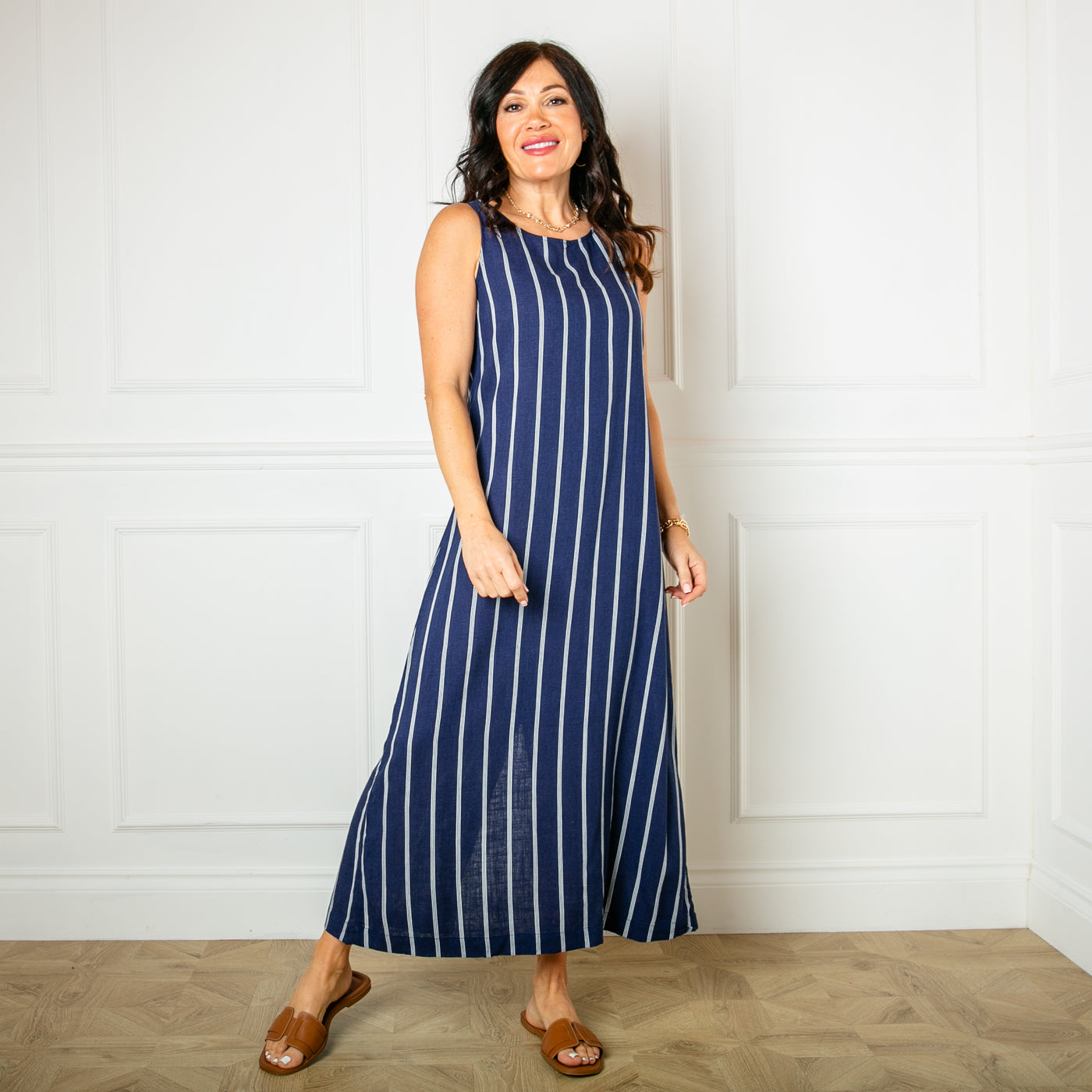 The navy blue Linen Tie Back Maxi Dress, sleeveless with an a-line silhouette and a round neckline