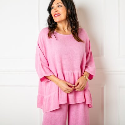 The Linen Blend Tiered Top in candy pink with a loose tiered peplum silhouette