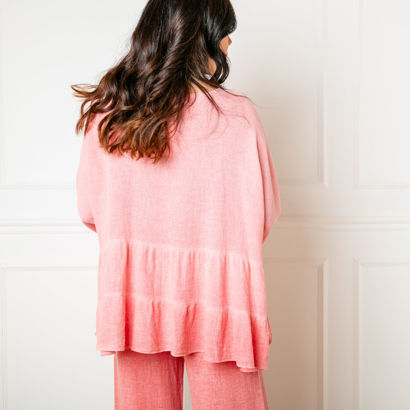 The coral orange Linen Blend Tiered Top made from a mix of cotton and linen for a lightweight relaxed summer look