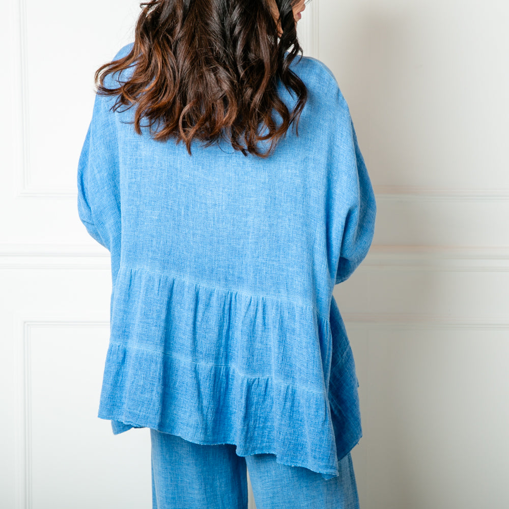 The Linen Blend Tiered Top in cornflower blue with 3/4 length sleeves and a round neckline