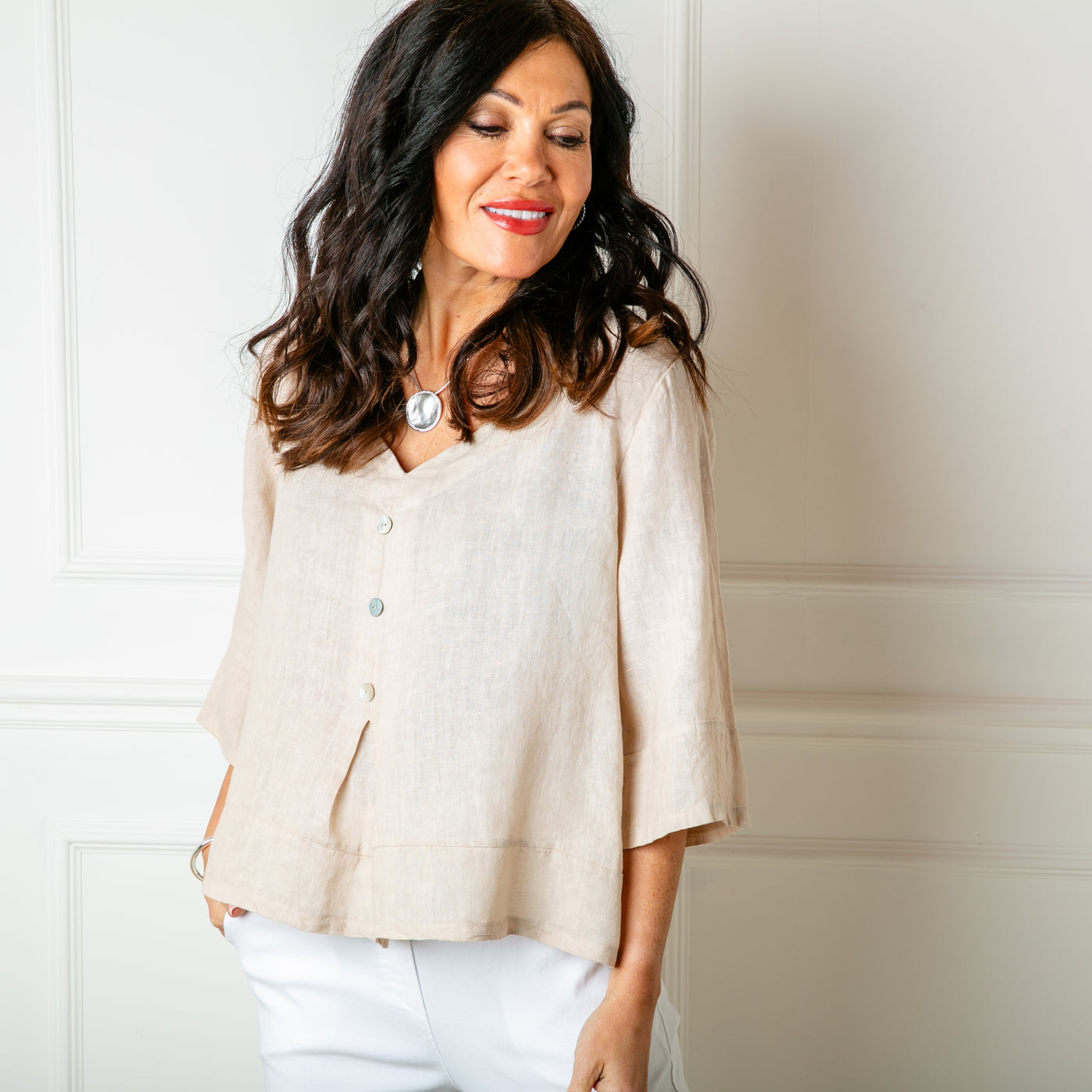 The natural cream stone Linen Button Pleat Top with 3/4 length sleeves and a v neckline
