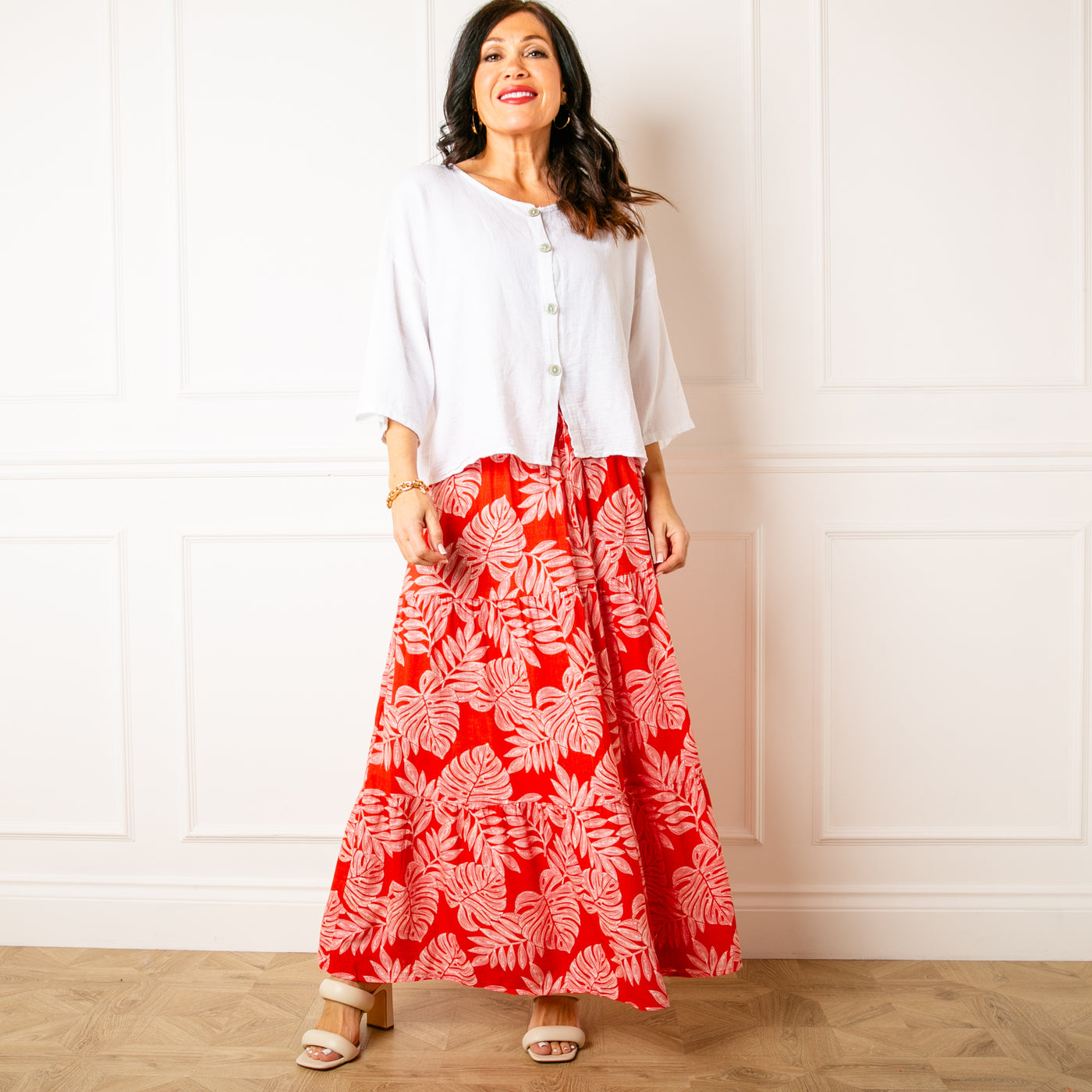 The red Linen Leaf Tiered Skirt featuring a beautiful tropical print in a viscose and linen blend material