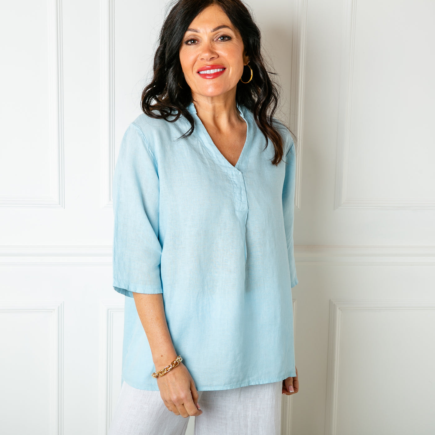The Linen Tunic Top in baby blue with 3/4 length sleeves and a collarless v neckline