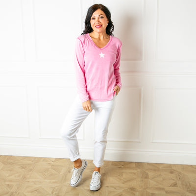 The pink Long Sleeve Star Top made from a stretchy cotton material 