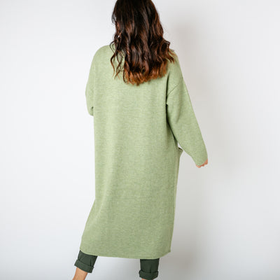 The pistachio green Longline Roll Collar Coatigan with pockets on either side of the hips