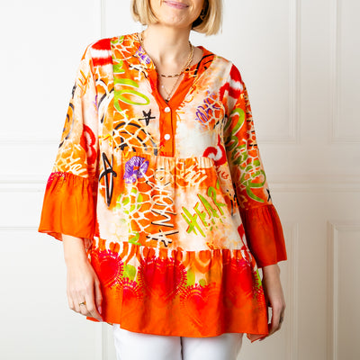 The orange Los Angeles Top with a v neckline and buttons down the front