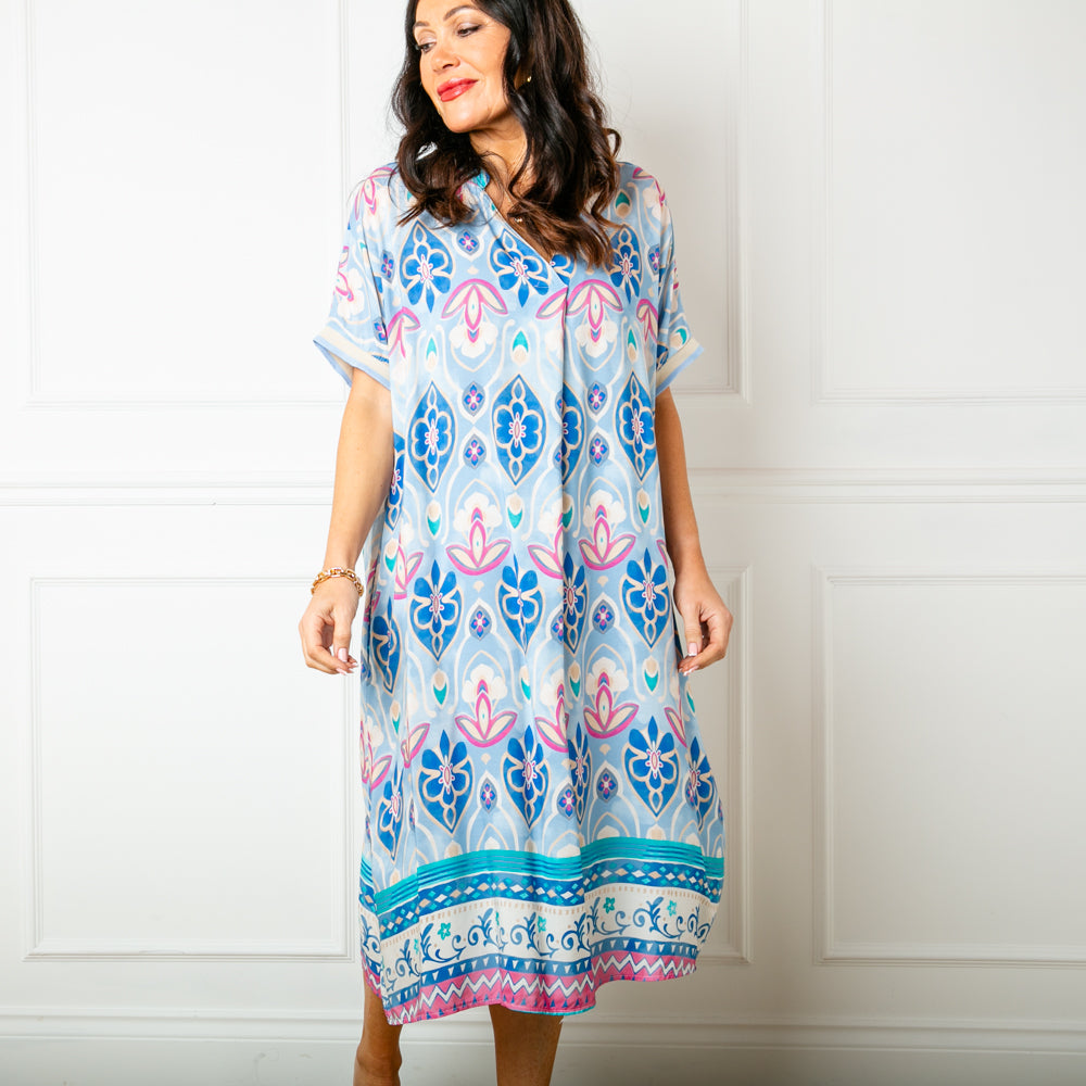 The Pastel blue Lotus Flower Sun Dress with short sleeves that have a ribbed stretchy cuff around the edge