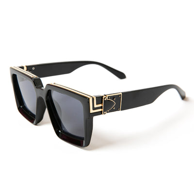 The Madonna Sunglasses with thick chunky black frames with gold detailing around the edges