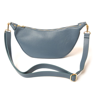 The denim blue Manhattan Leather Crossbody Handbag with a matching detachable strap and gold coloured hardware