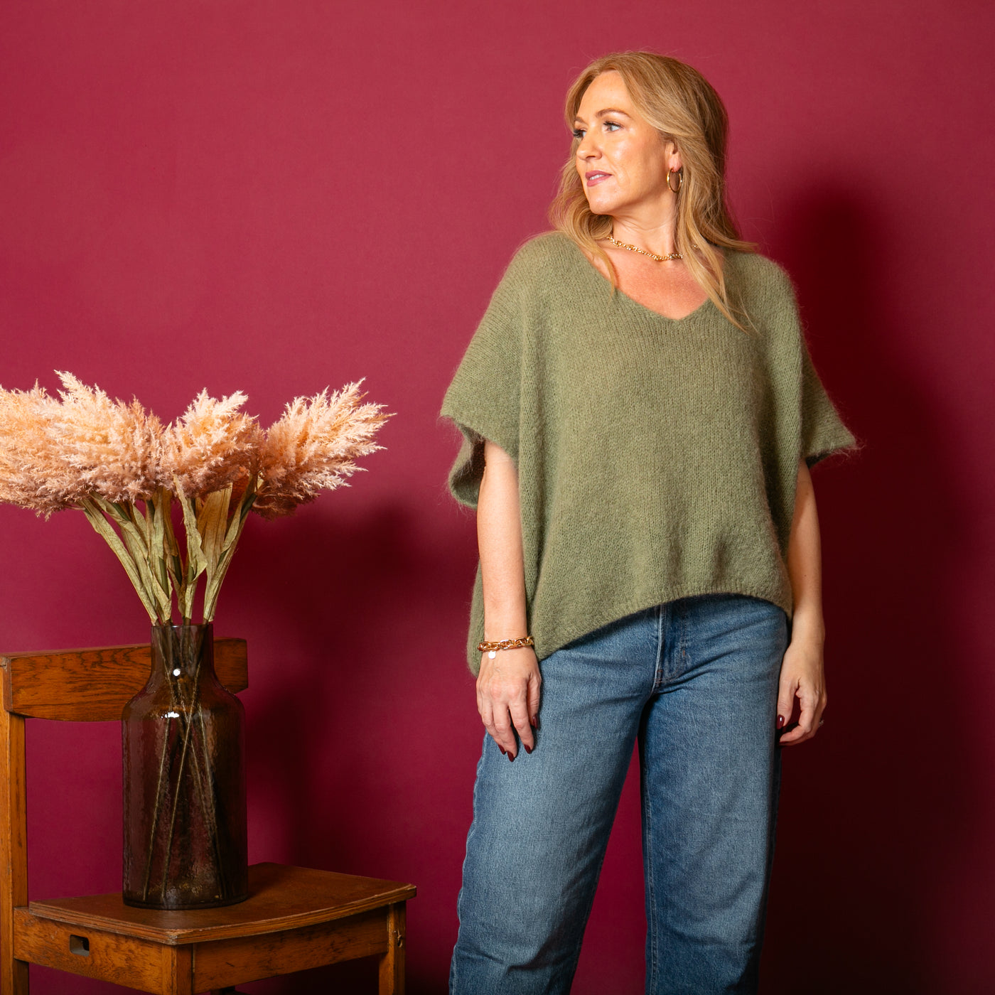 The Olive Green Mohair Tank Top with a v neckline and a relaxed fit