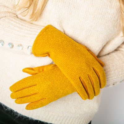 The Mollie Gloves in mustard yellow which make the perfect finishing touch for any winter outfit