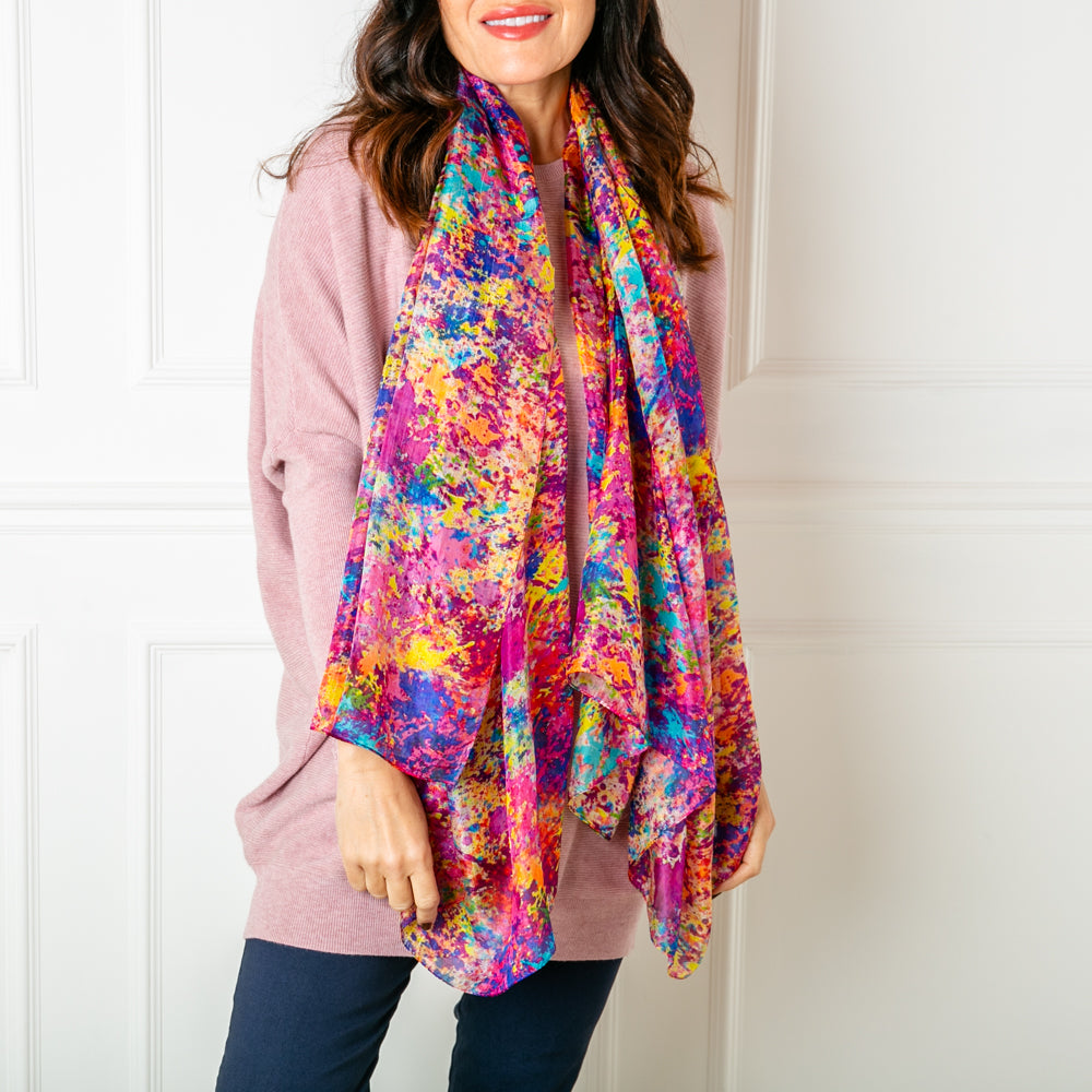 The Multicolour Spritz Silk Scarf featuring a vibrant print with shades of pink purple blue yellow orange and red