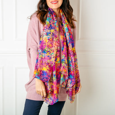 The Multicolour Spritz Silk Scarf featuring a vibrant print with shades of pink purple blue yellow orange and red