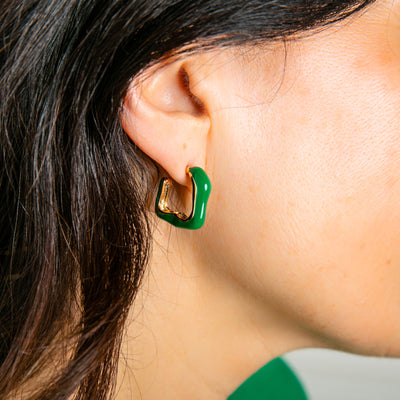 The Nadine Earrings in emerald green, available in gold and silver plating