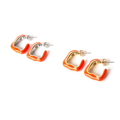 The Nadine earrings in orange with a quirky shape and butterfly back fastenings