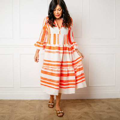 The Neon Folk Dress in orange with 3/4 length sleeves that have a flared cuff