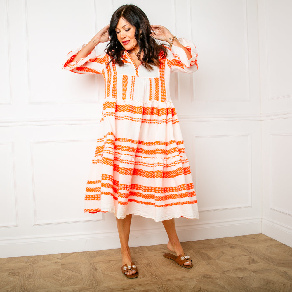 The Neon orange Folk Dress with a v neckline and a tiered midi skirt