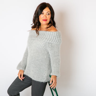 The Off Shoulder Jumper in grey made from a chunky knitted blend of nylon and acrylic