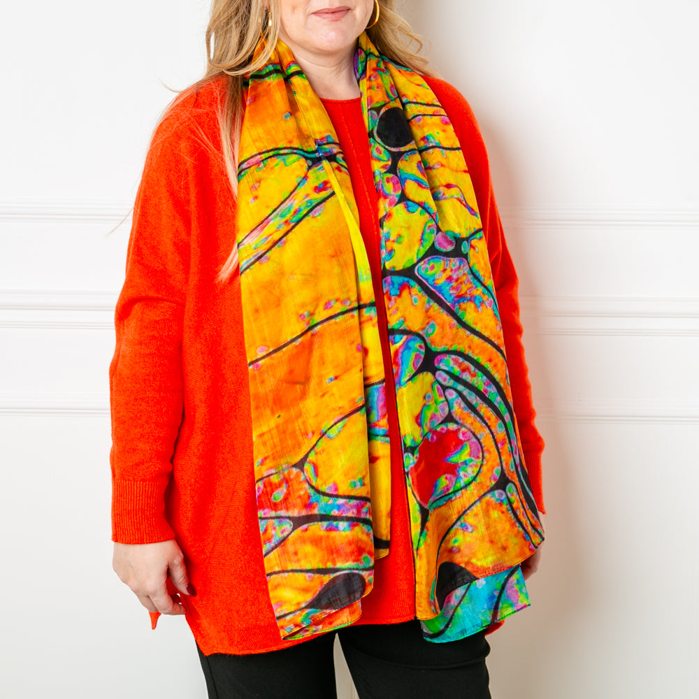 The Orange Oil Spill Silk Scarf which makes a great present gift for someone special