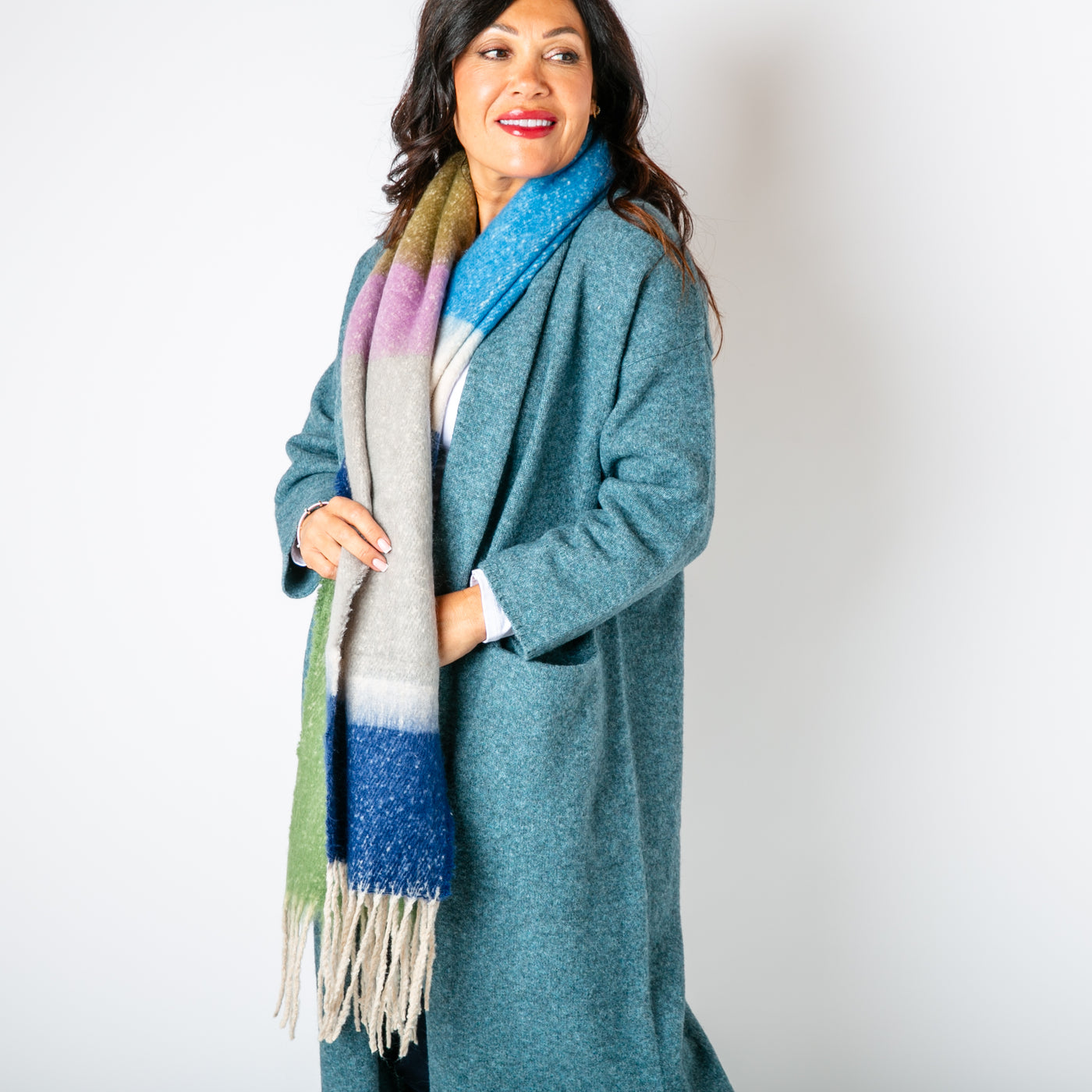 The Ozzy Multicolour Scarf in Blue Sea made from a super soft chunky knit with tassels at either end