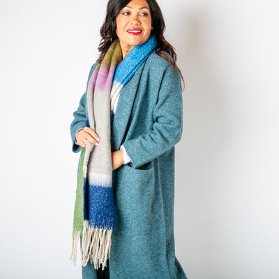 The Ozzy Multicolour Scarf in Blue Sea made from a super soft chunky knit with tassels at either end