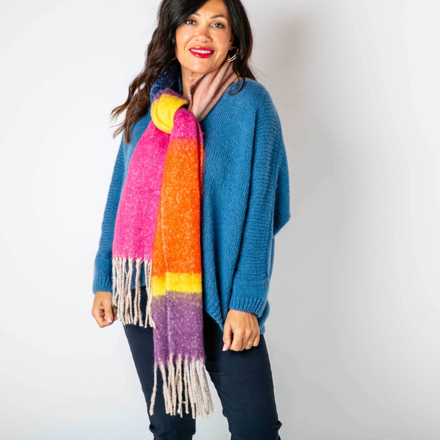 The Ozzy Multicolour Scarf in Rhubarb made from a super soft chunky knit with tassels at either end