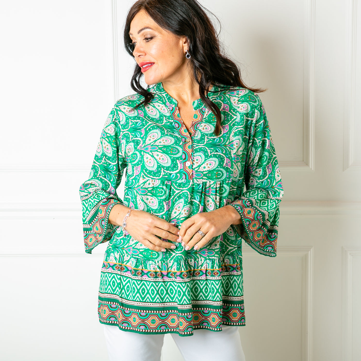 The green Paisley Blouse with 3/4 length sleeves that are flared at the elbow