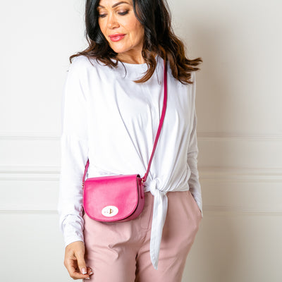 The Paris Leather Handbag in raspberry pink with a long, leather adjustable strap
