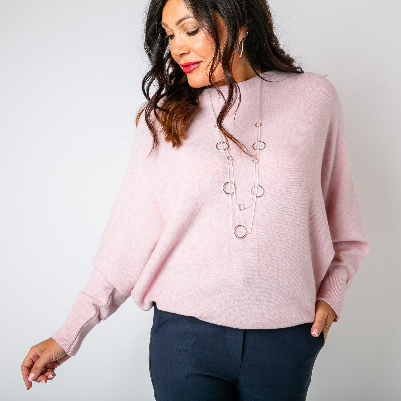 The dusky pink Pearl Back Jumper with a beautiful pearl button detail running down the back of the jumper