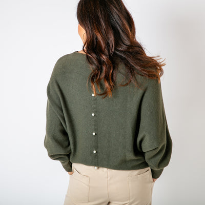 The khaki green Pearl Back Jumper with a beautiful pearl button detail running down the back of the jumper