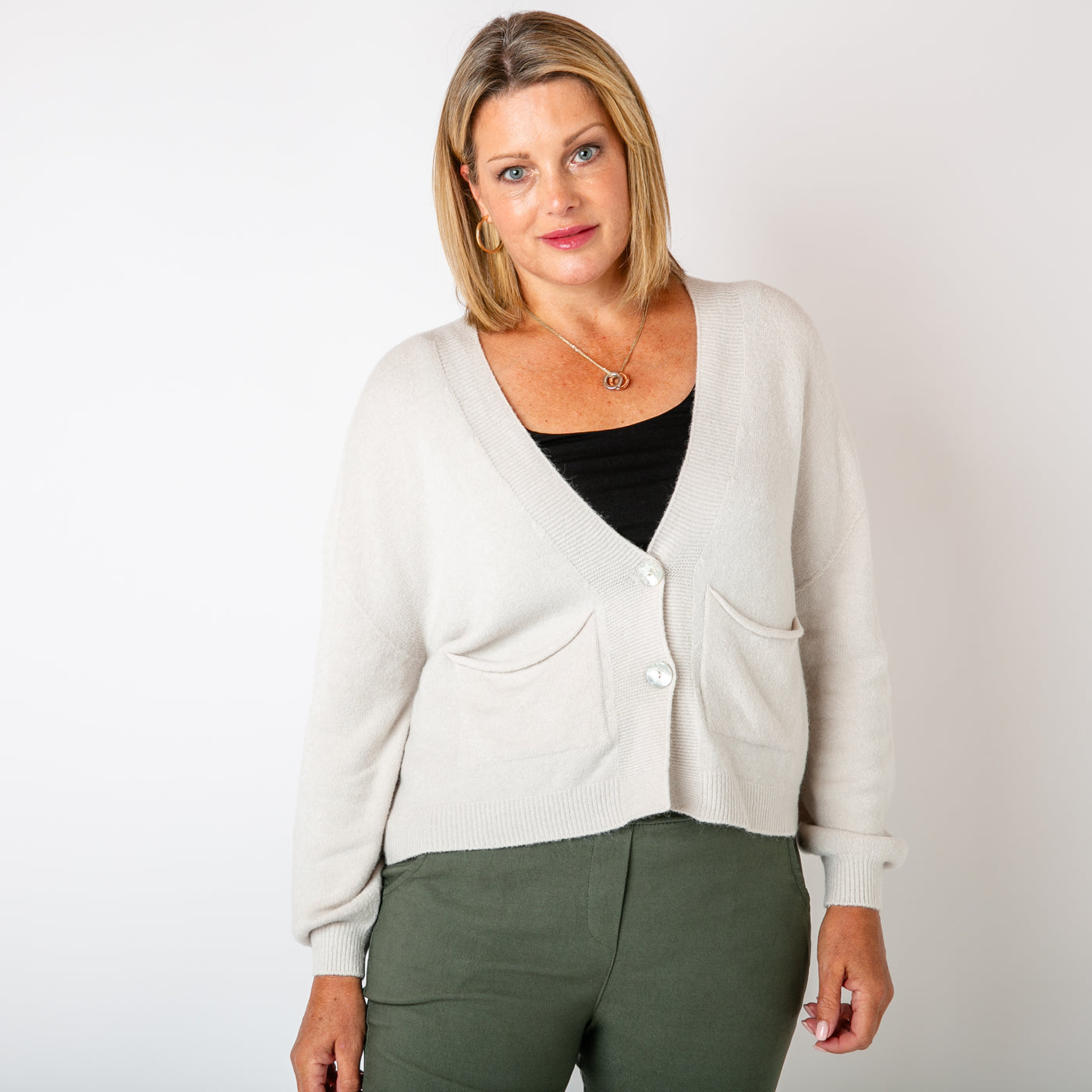 The cream Pearl Button Cardigan made from a super soft, fine knitted blend