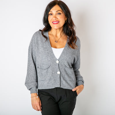 The grey Pearl Button Cardigan with pockets on either side of the chest