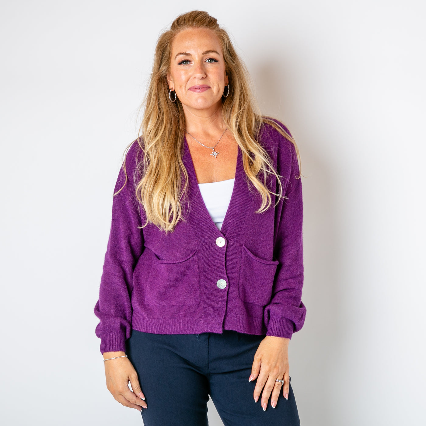 The purple Pearl Button Cardigan with pockets on either side of the chest