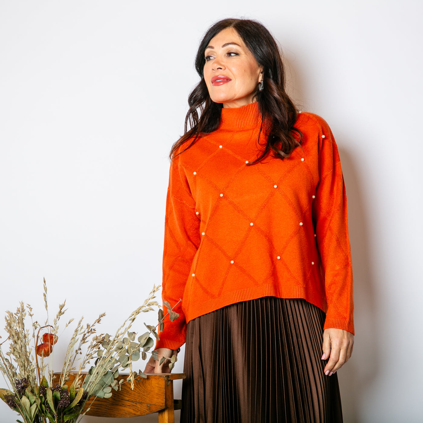 The orange Pearl Detail Mock Neck Jumper with long sleeves and a high neckline