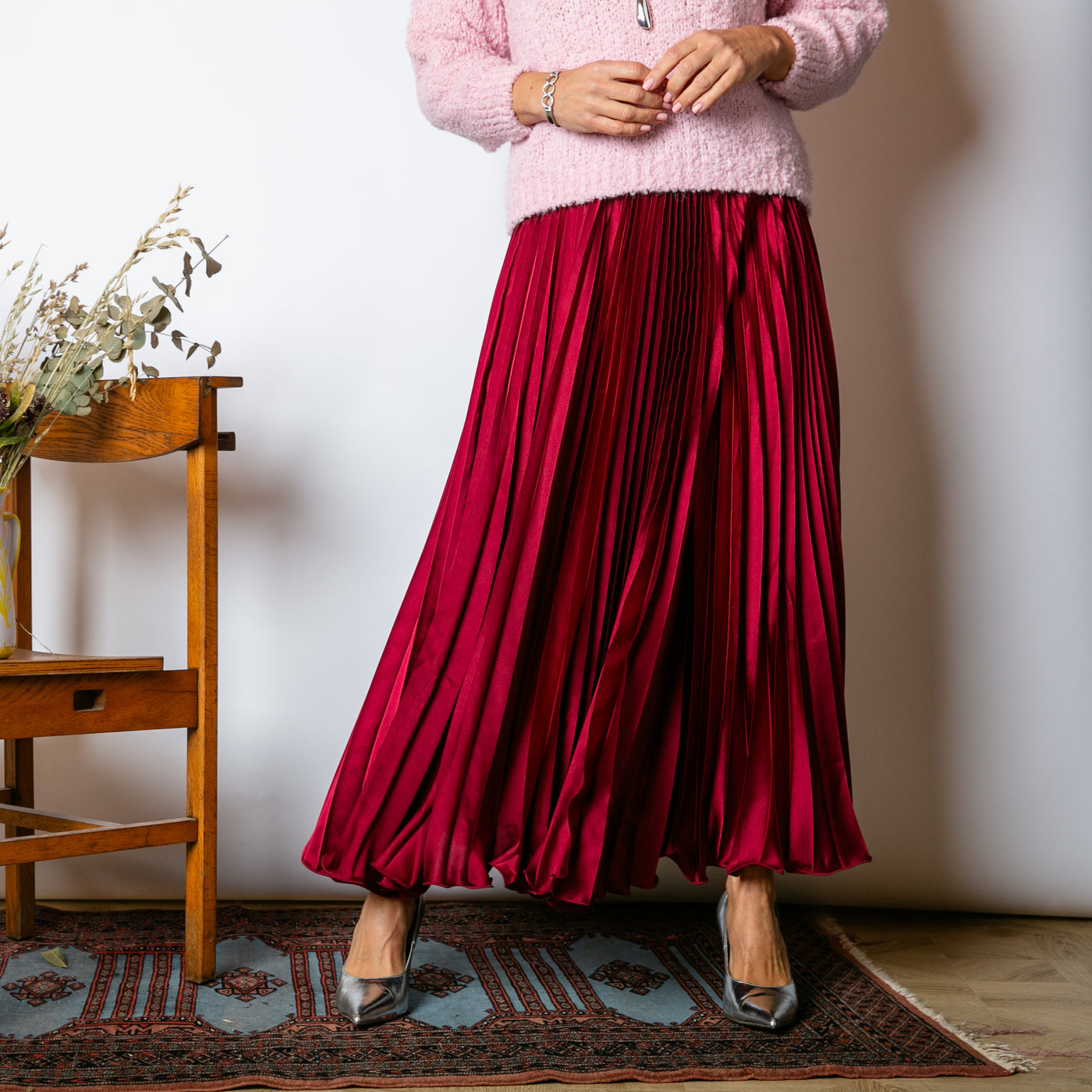 The Pleated Cocktail Skirt in burgundy red with elastic around the back of the waistband