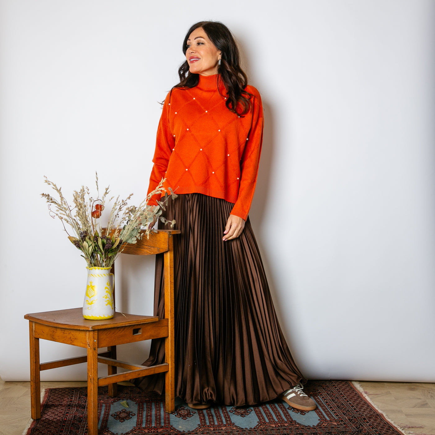 The Pleated Cocktail Skirt in chocolate brown with elastic around the back of the waistband